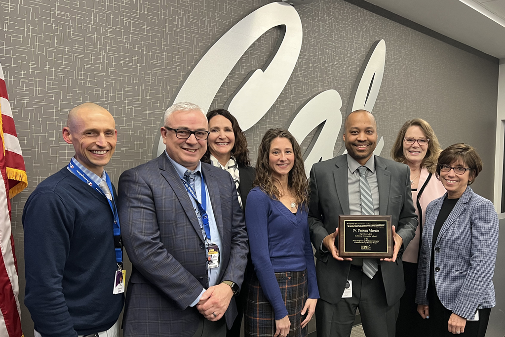 Group photo with Dr. Dedrick Martin shown holding his award