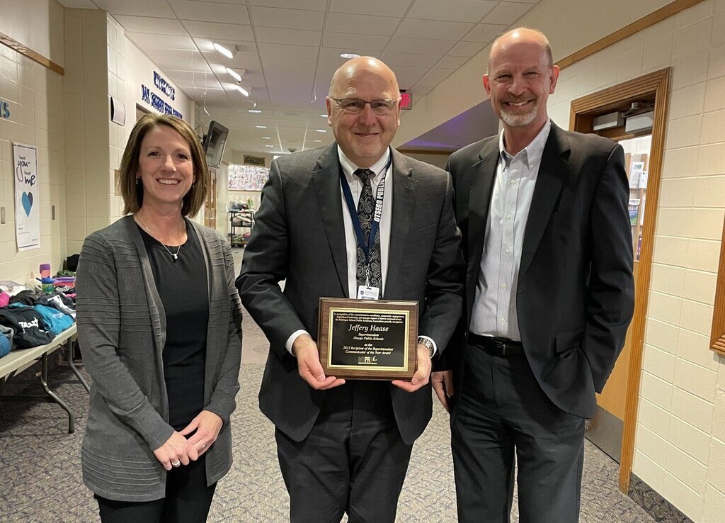 Holly McCaw, APR, Superintendent Jeffrey Haase and Tom Scheidel, APR